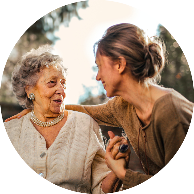 women holding elderly mother's hand